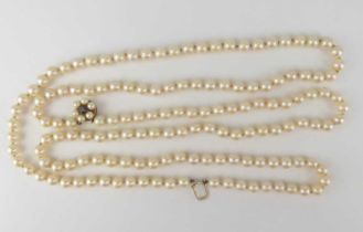 A double-string cultured pearl necklace united with a 9ct gold ruby and seed pearl flower head
