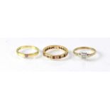 Four 9ct gold rings, one set with moss agate style stone, size R, an eternity ring set with white