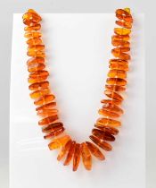 An amber-style bead necklace of naturalistic graduated form, length approx. 68cm, together with a