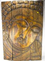 A modern four-fold carved wooden screen, the front depicting the head of Buddha, the reverse rough