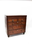 A Victorian mahogany chest of two short over three long graduated drawers, with wooden handles, on