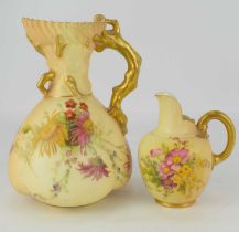 WORCESTER; two blush ivory floral decorated porcelain ewer jugs, the tallest with branch handles,