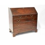 A George III mahogany bureau, the fall front enclosing a simple fitted interior, with gilt tooled
