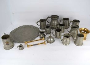 A quantity of pewter mugs of various sizes, height of largest 15cm, a pewter tray, diameter 37.