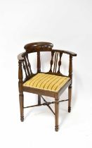 A mahogany corner chair.