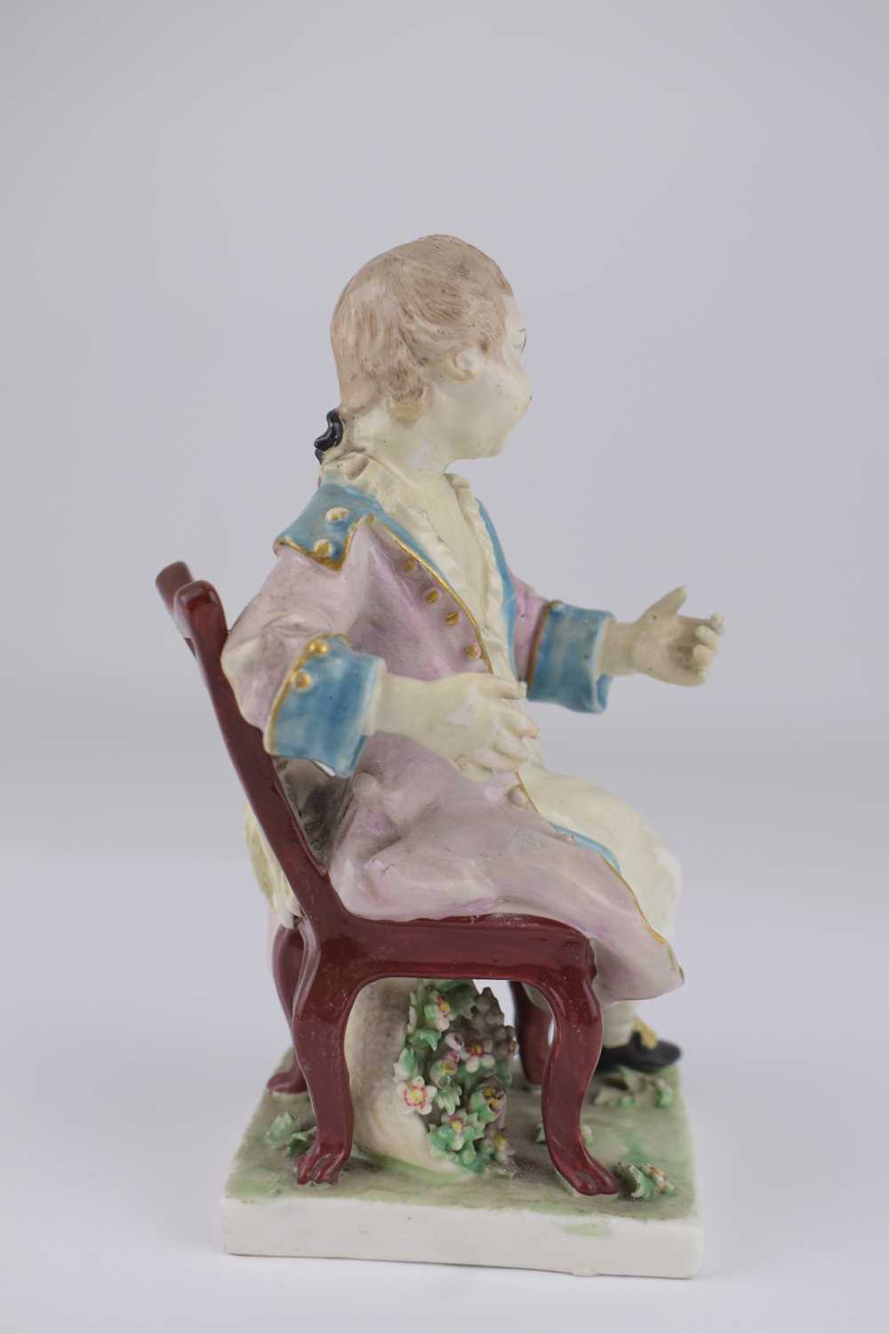 DERBY; an 18th century porcelain figure depicting a boy with coat, sat on a chair, height 14.5cm, on - Image 4 of 5