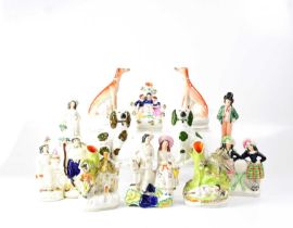 A group of Staffordshire figures, including a pair of seated hounds, three spill vases, etc.