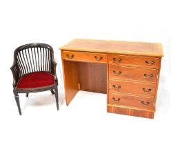 A modern light wood desk with two drawers over a cabinet, with three-drawer faux front, tooled brown