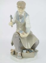 LLADRÓ; a high glaze porcelain figure of a cobbler, height 25cm, with factory mark to base.