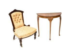 A Victorian walnut framed low nursing side chair raised on turned front supports to castors, and a