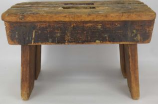 A late 19th/early 20th century rustic pine stool, with handle slot to the centre, 29 x 40 x 29.