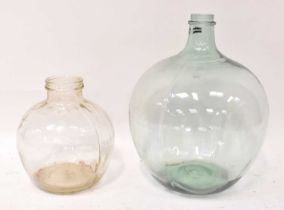 A green glass carboy, height 55cm, together with a smaller clear dimpled glass example, height
