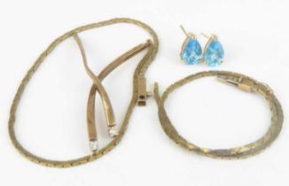 A pair of 14ct gold earrings with a blue claw set topaz of pear shape (lacking fasteners),