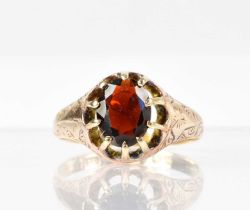 A 9ct yellow gold ring claw set with single oval garnet, size P/Q, approx. 3g.