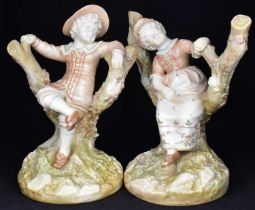 HADLEY WORCESTER; two c.1890 Royal Worcester figures modelled as children seated in branches, in