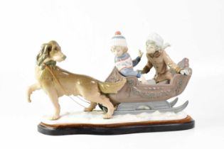 LLADRÓ; a figure group 'Sleigh Ride' with two young children being pulled in a sleigh by a dog,