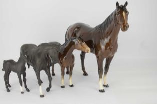 BESWICK; four horses, comprising a large brown gloss racehorse, height 31cm, a brown gloss mare,