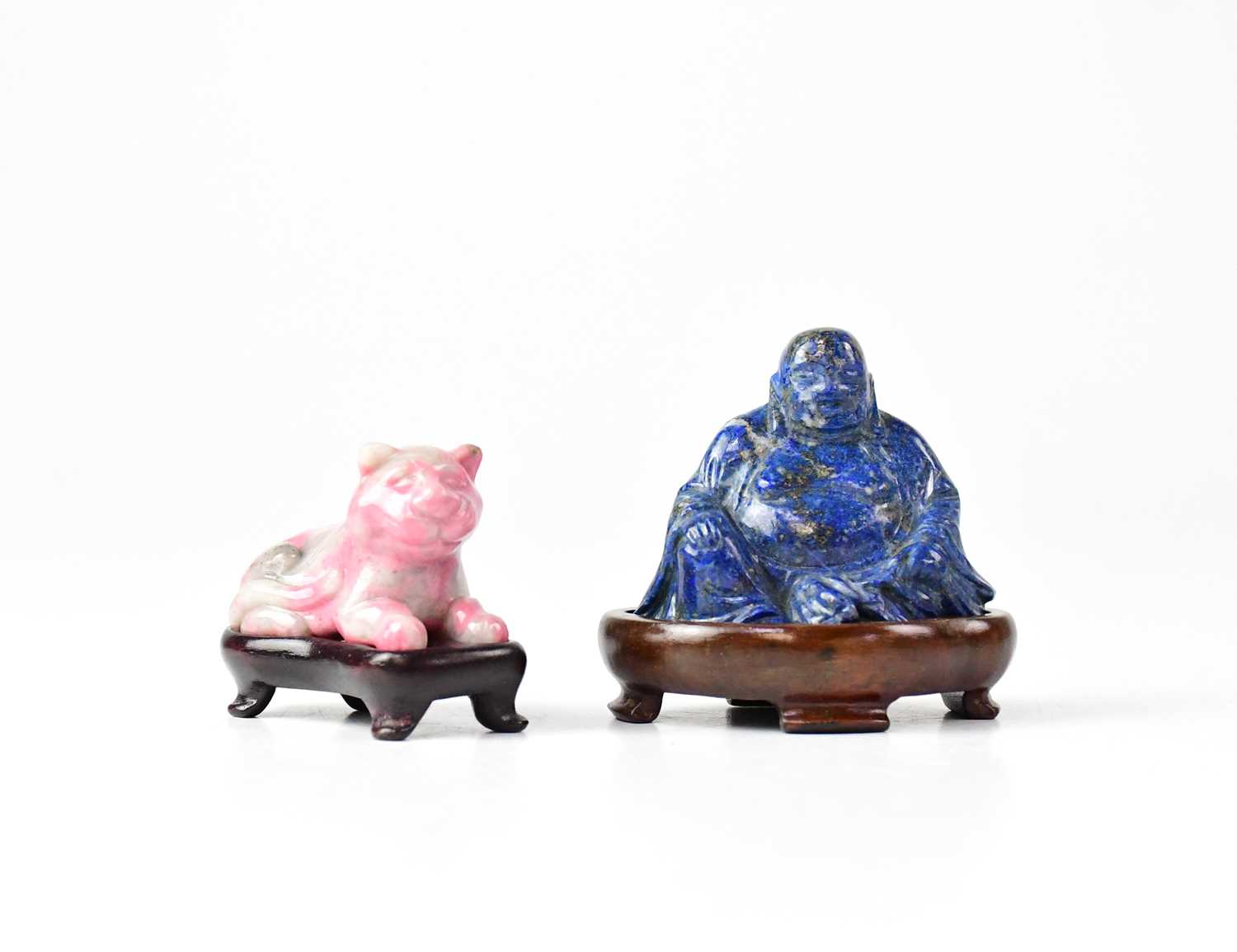 A carved lapis lazuli figure of a Buddha on a wooden stand, height of figure 4.8cm, and a carving of