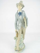 LLADRÓ; a large porcelain figure of a travelling artist, height 36.5cm, with factory mark to base.