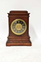 An early 20th century mahogany cased mantel clock, the brass and painted dial set with Roman
