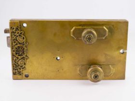 A late Georgian/early Victorian brass cased internal door lock with steel mechanism, the brass plate