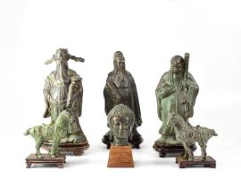 Three contemporary polished metal figures of Immortals on wooden stands, two polished metal
