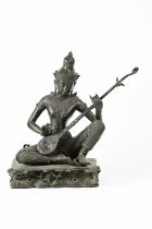 A 19th century Thai Rattanakosin Saraswati bronze of a seated figure, on a stylised Tree of Life