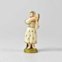 A 19th century English porcelain model of a girl playing a tambourine, in a gilt-highlighted dress