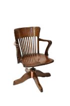 A vintage oak office chair with slatted back and shaped arms. Condition Report: Overall good