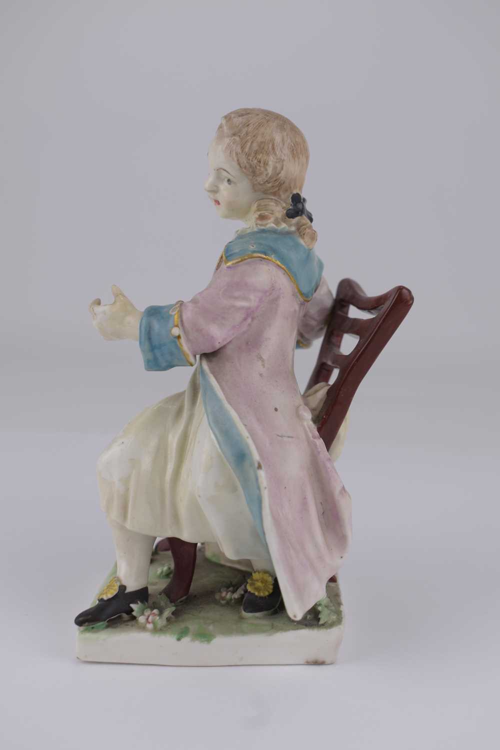DERBY; an 18th century porcelain figure depicting a boy with coat, sat on a chair, height 14.5cm, on - Image 2 of 5