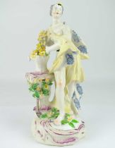 BOW; an 18th century porcelain figure depicting Flora (Spring), c.1760, wearing flowing robes, stood