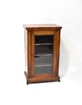 An early 20th century burr walnut pier cabinet with quart veneered top above single glazed door,