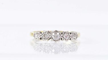 An 18ct yellow gold and platinum ring set with five diamonds, size N1/2, approx. 2.7g.