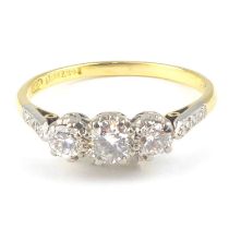 An 18ct gold three-stone diamond ring, with three platinum claw set brilliant cut diamonds,