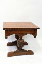 An early 20th century oak fold-over draw-leaf table, raised on carved bulbous cross-stretchered