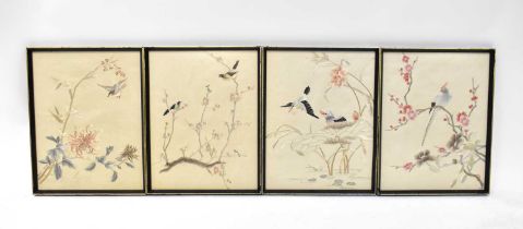 A set of four Japanese silk embroidered pictures, a larger example with a bird in a branch, a set of