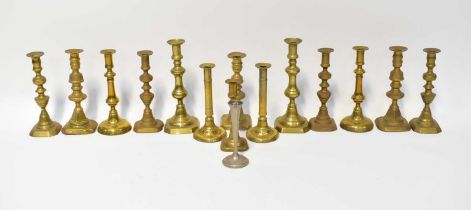 A collection of fourteen brass candlesticks, some matching, tallest 28cm, and a silver plated