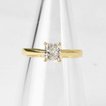 An 18ct gold diamond solitaire ring set with a radiant cut diamond in a claw setting, approx. 1ct,