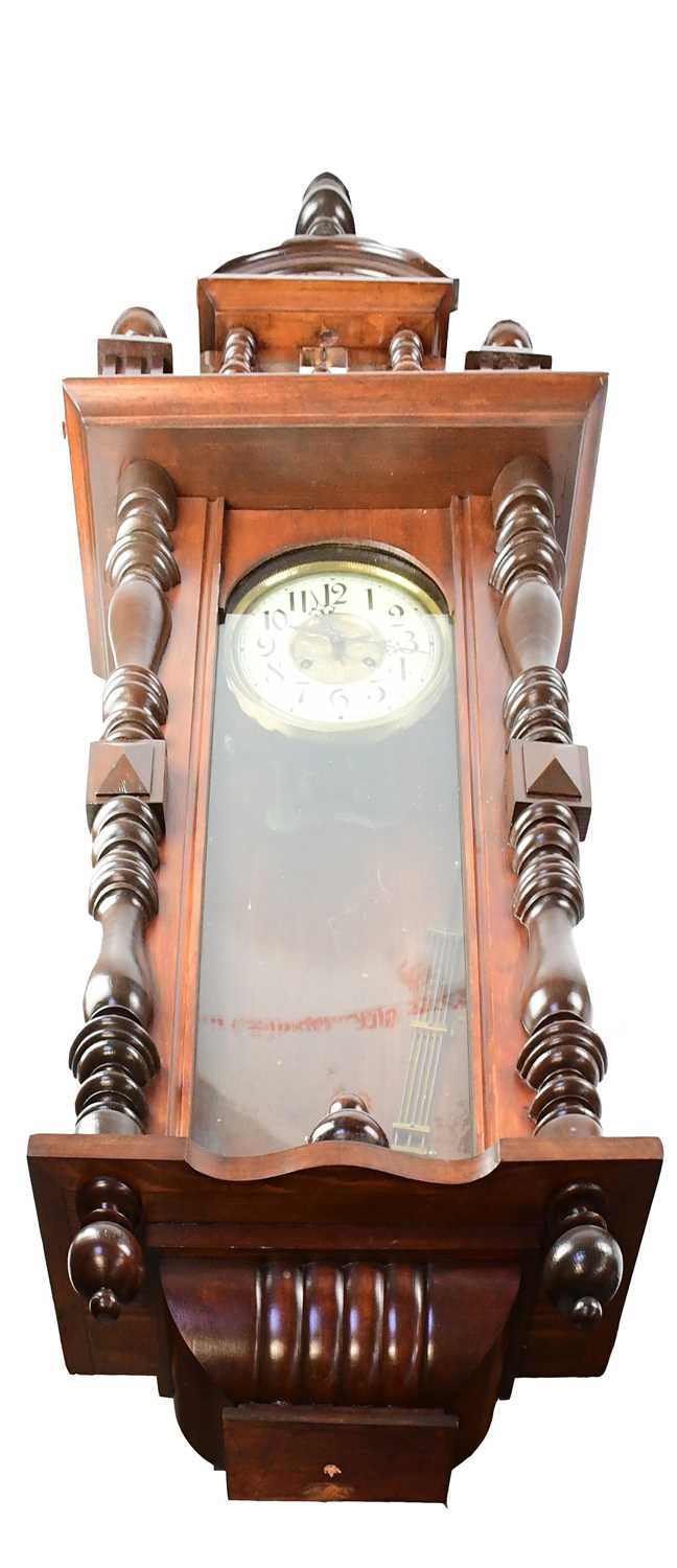 A Vienna wall clock in a mahogany case, with arched pediment, the dial with ivorine chapter ring set