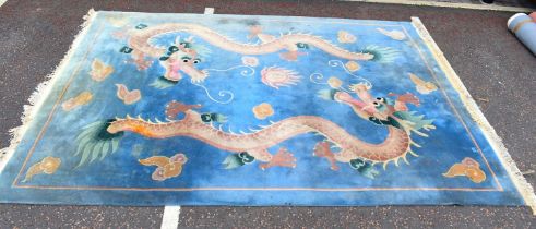 A modern Chinese carpet with pair of Chinese dragons on a blue ground, 385 x 270cm.