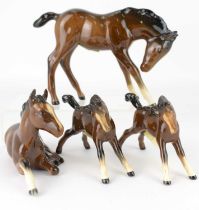 BESWICK; four brown gloss foals, the largest 10.5 x 13cm (4).