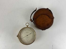 STANLEY; a leather cased brass compensated barometer, diameter 12cm.