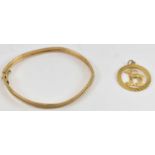 A 9ct gold bangle and pendant, combined approx 8.6g.