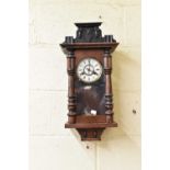 A 20th century wooden cased drop dial wall clock with Roman numerals.