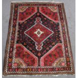 A hand knotted Persian red ground Hamadan rug, 138 x 104cm.