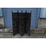 An Eastern carved and pierced hardwood four leaf folding screen, height 150cm to top of finial.