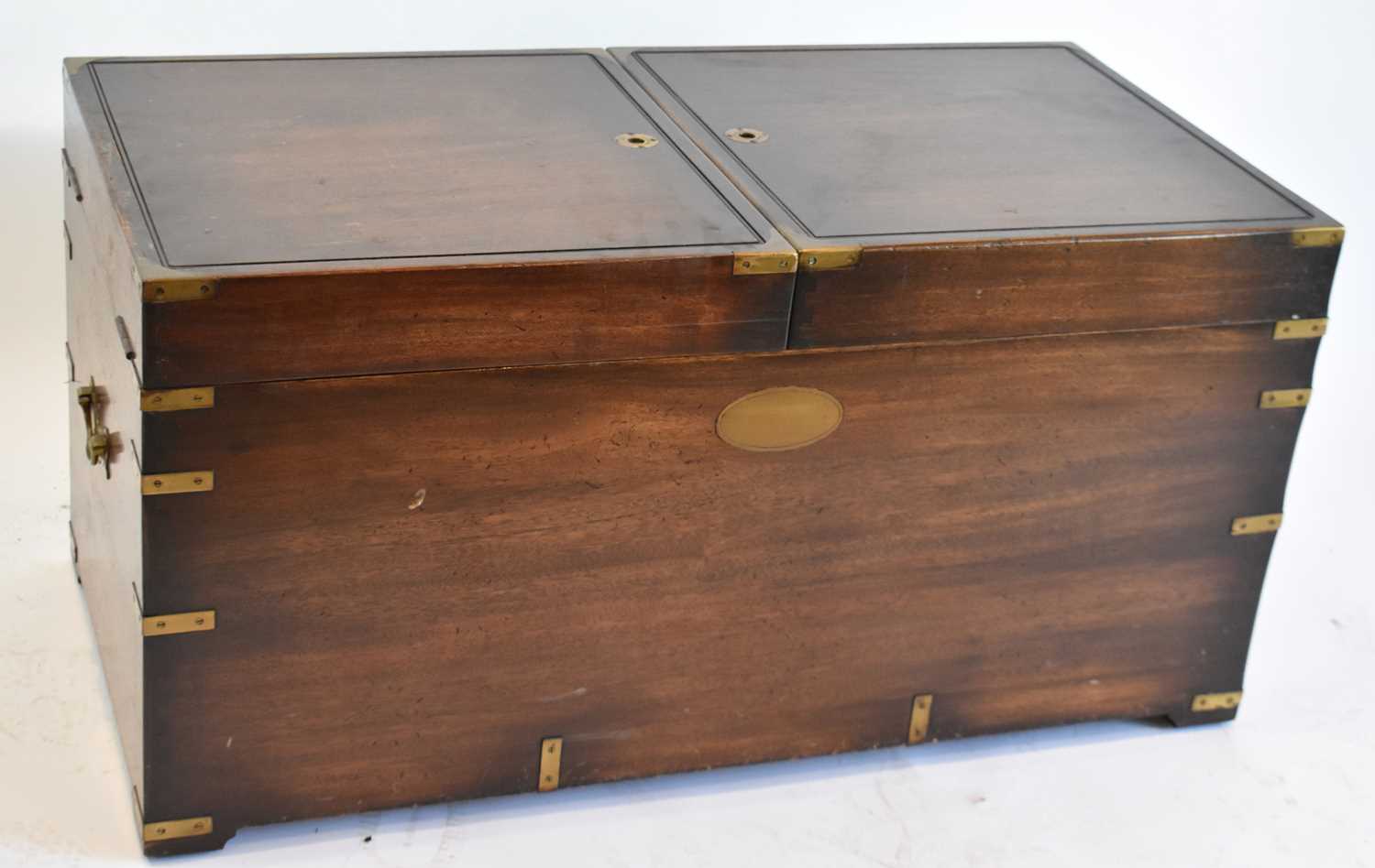 A reproduction mahogany military style chest, with twin hinged lid and brass carrying handles, width