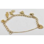 A 9ct gold charm bracelet suspending five assorted charms and a padlock, approx 12.4g.
