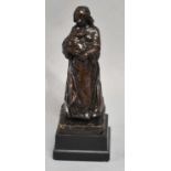 GILBERT; a late 19th century bronze figure of mother and child, signed on slate base, height 19.