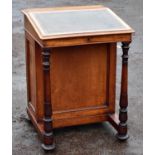 A Victorian mahogany Davenport desk with four drawers opposing four faux drawers with turned front